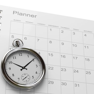 photograph of a fob watch and a planner